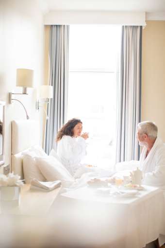 Couple enjoying breakfast in bed