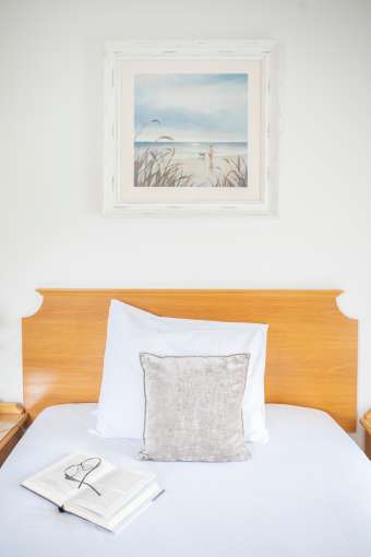 Close up of cushions on single hotel bed