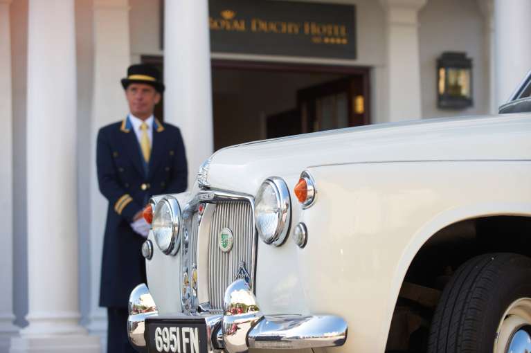 Vintage cream Rolls Royce parked in front of the Royal Duchy Hotel for a wedding