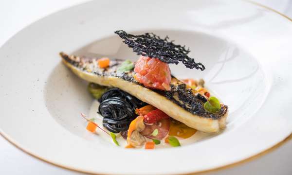 Mackerel with squid ink linguini, marinated tomato sorrel and clams