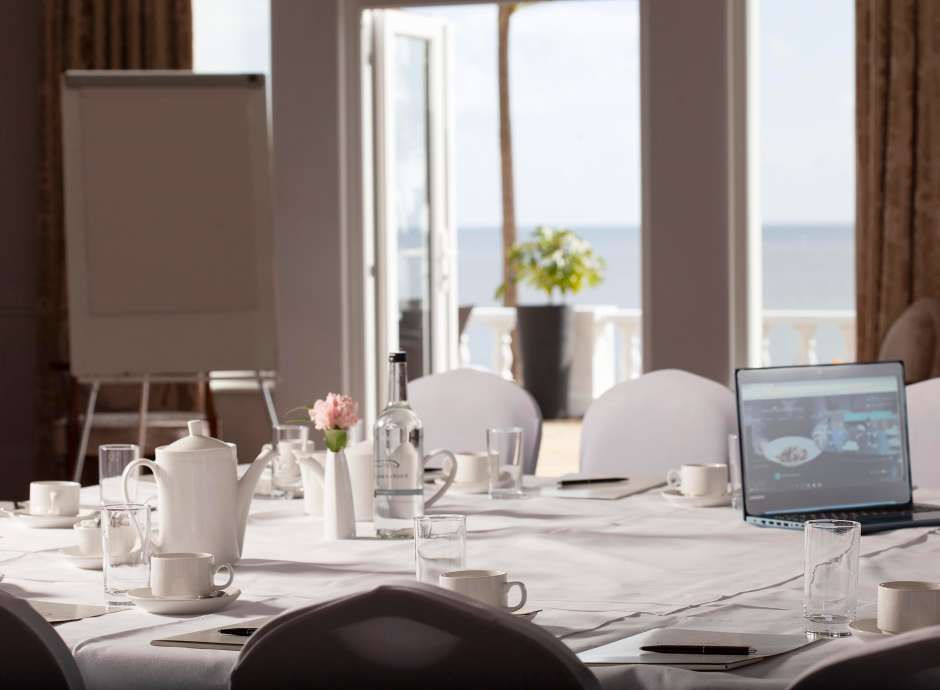 Function room set for meeting with sea view in window