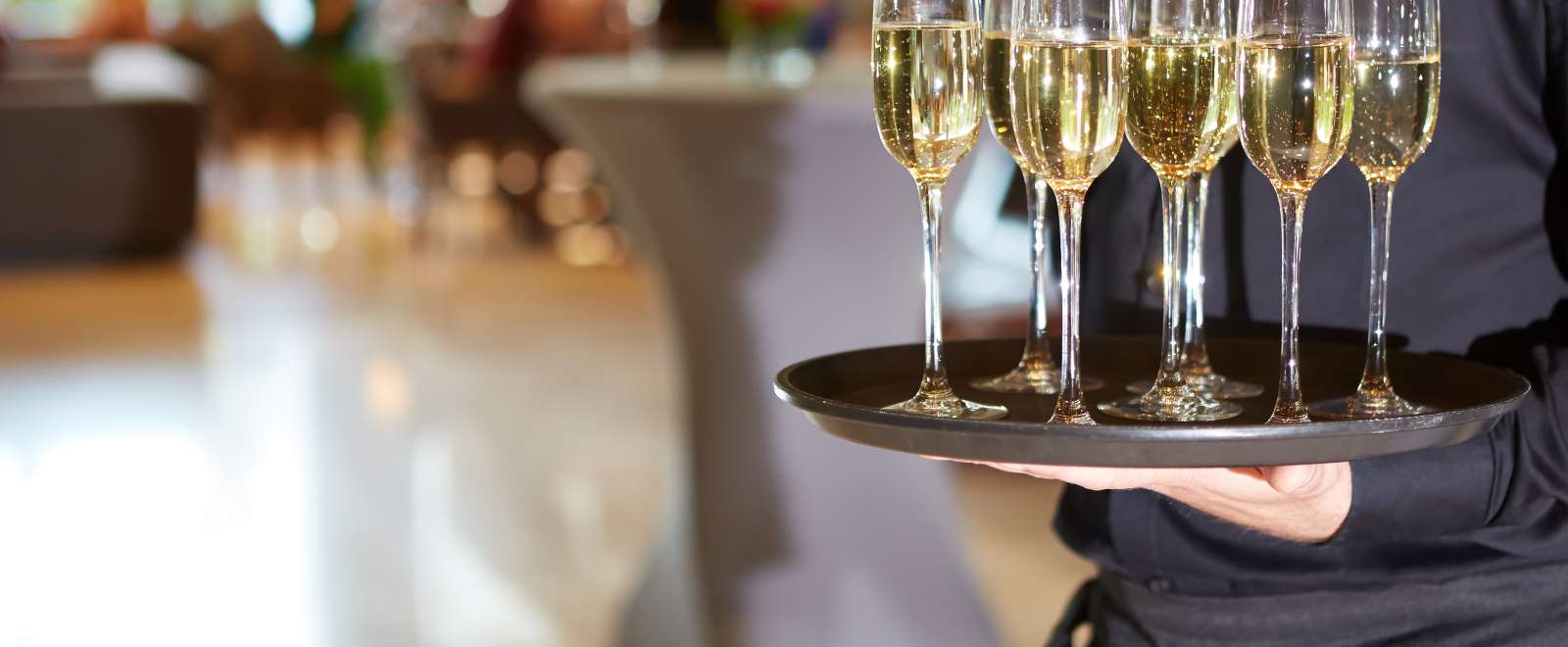 Server with a tray of champagne at a wedding reception