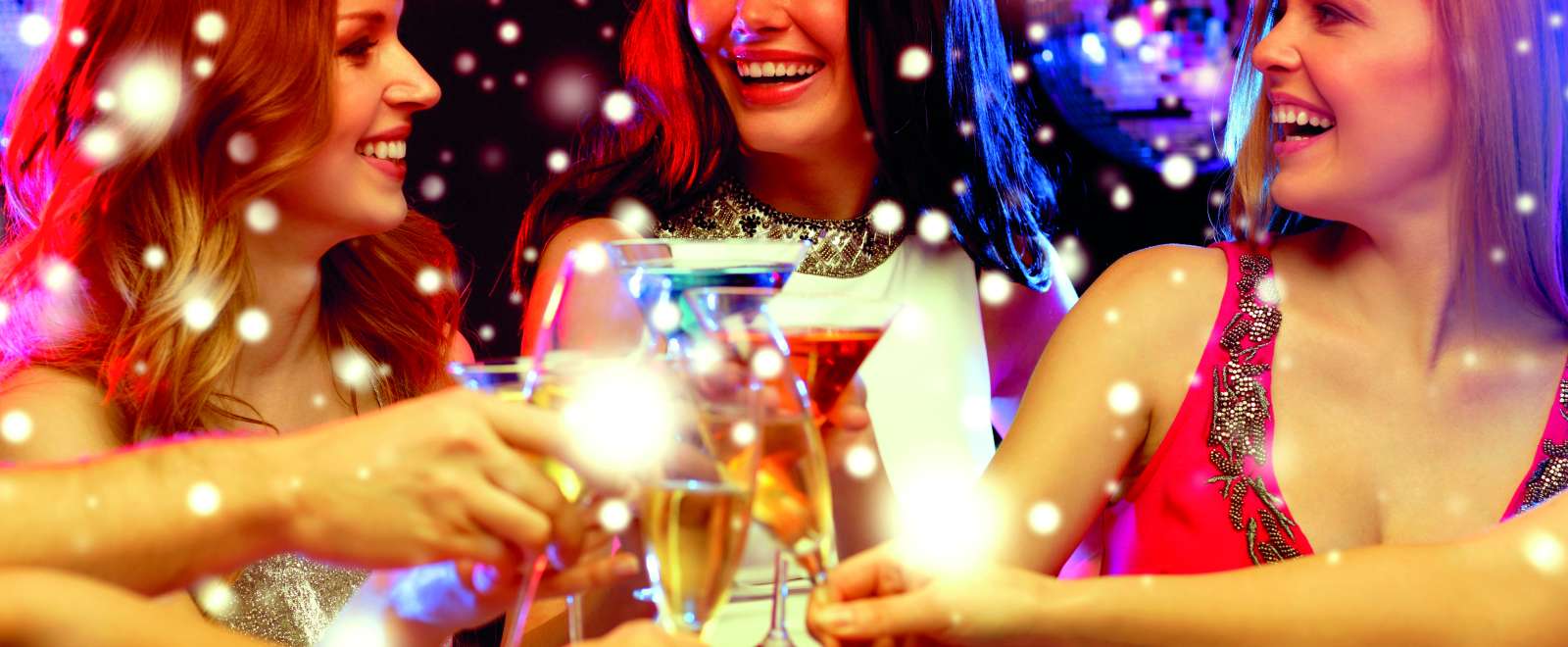 People clincking their drinks at a party with snow around them