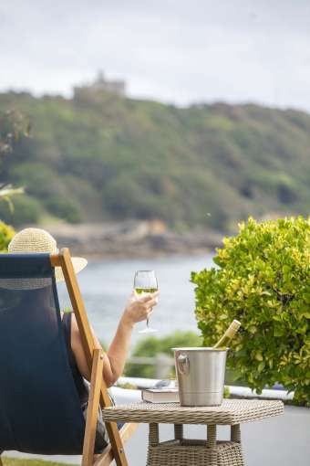 Royal Duchy Hotel Guest in Deck Chair with Wine Looking Out at Pendennis