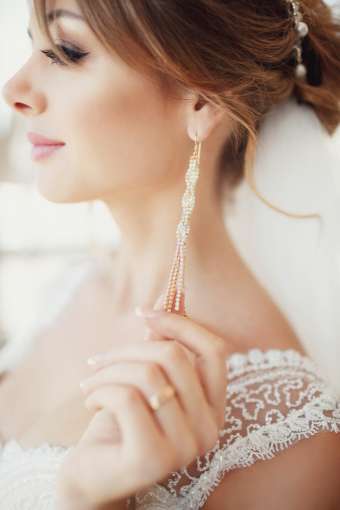 Bride touching her earring as she gets ready