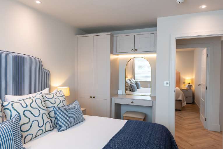 Bedroom with door open at The Duchy Beach House
