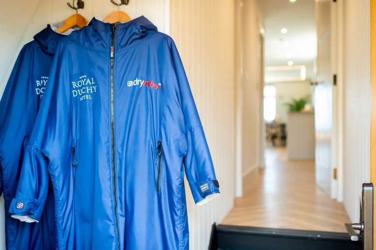 Dry robes hanging in the entrance of The Duchy Beach House
