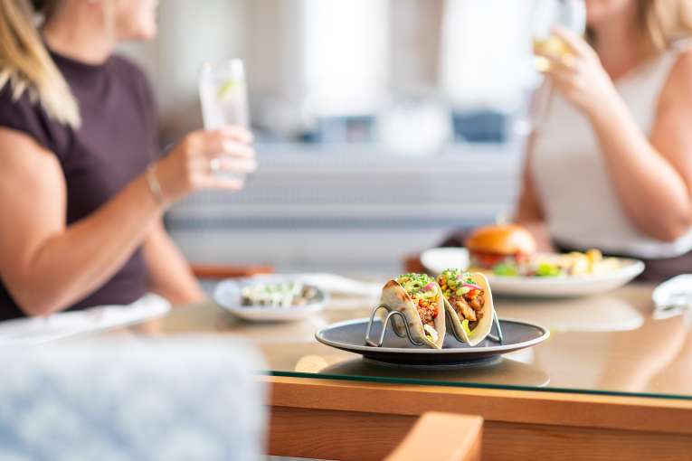 Tacos with ladies drinking in the background The Royal Duchy Hotel