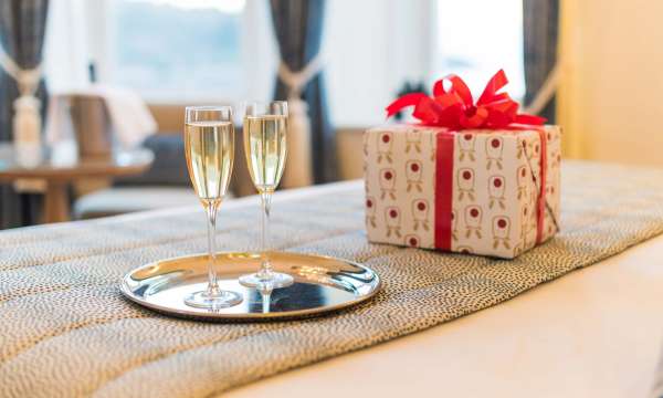 Royal Duchy Hotel Christmas Present and Flutes of Champagne on Bed in Room