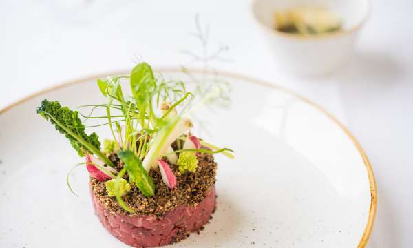 A spiced beef tatare, romanesco, broccoli mooli, radish and parmesan with truffle dressing