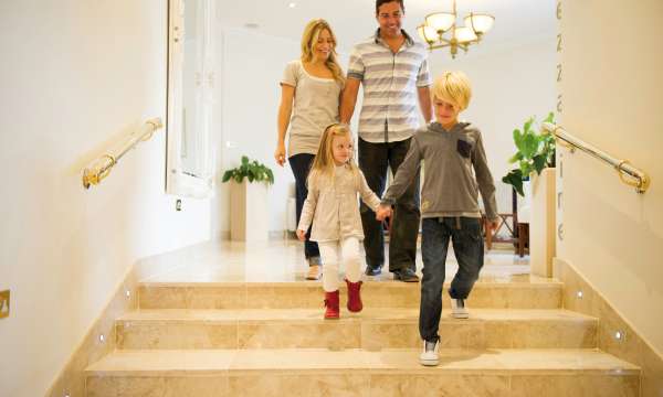 Young family of four walking down stairs at The Royal Duchy Hotel