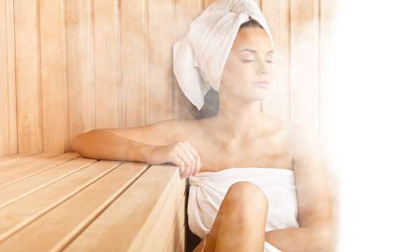 Woman in sauna steam on face spa