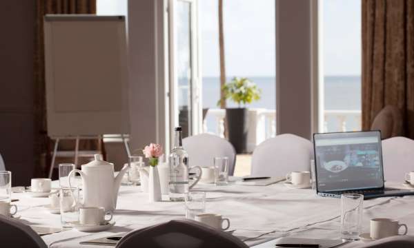 Function room set for meeting with sea view in window