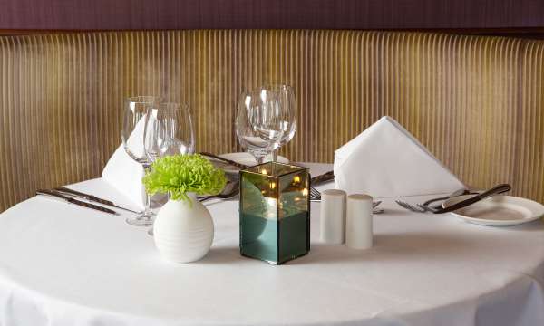 Dining table set for tea with candle and flowers