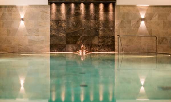 Woman in source spa indoor pool relaxing