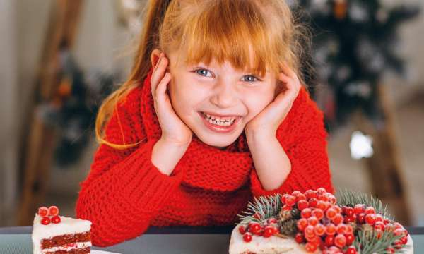 Smiling child with Christmas Cake