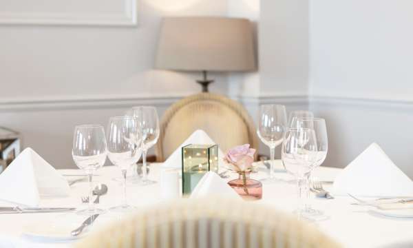 Picture of table laid up for Mothers Day lunch with rose in a vase 