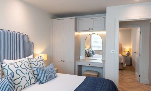 Bedroom with door open at The Duchy Beach House
