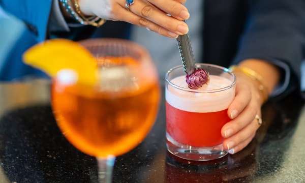 Lady making cocktail at the bar