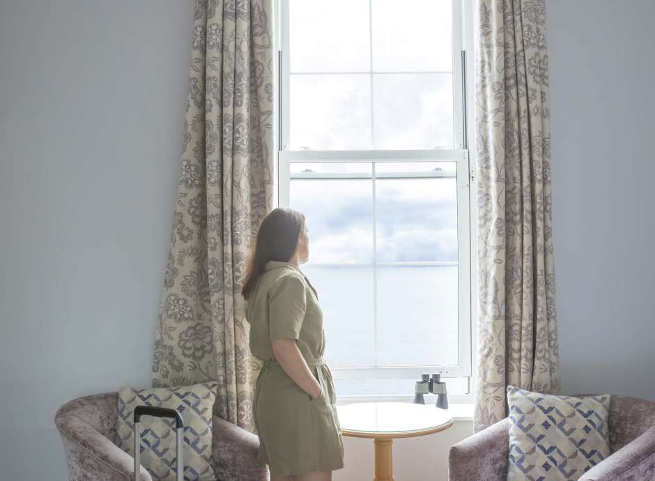 Royal Duchy Hotel Guest Arriving in Her Room and Taking In the Sea View from the Window