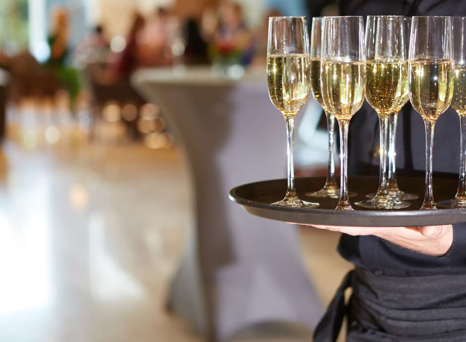 Server with a tray of champagne at a wedding reception