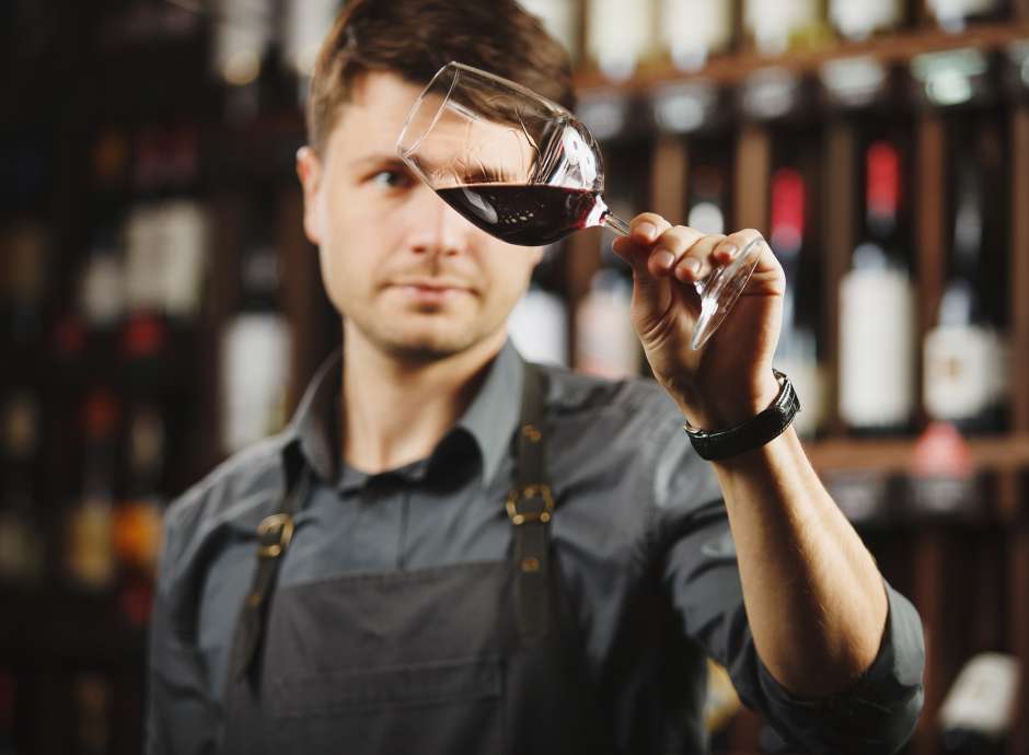 Wine sommelier swilling glass of red wine