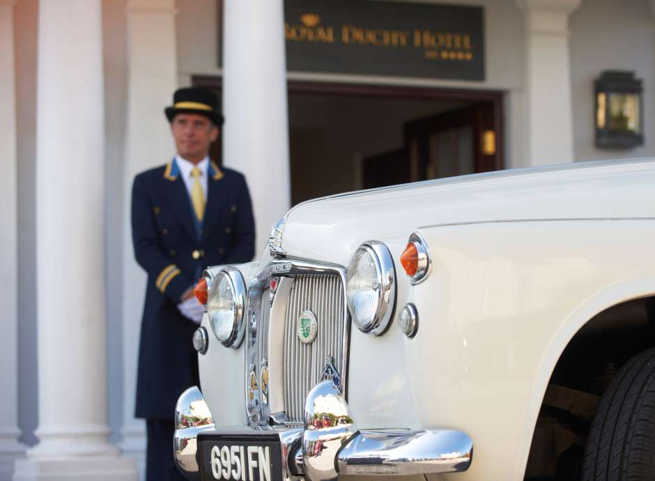 Vintage cream Rolls Royce parked in front of the Royal Duchy Hotel for a wedding