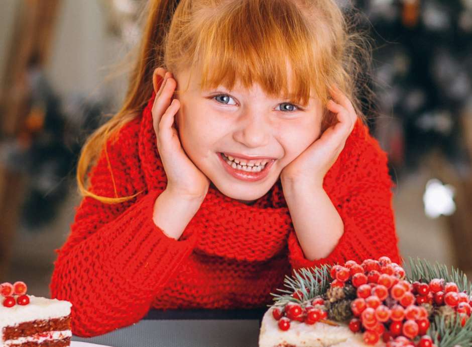 Smiling child with Christmas Cake