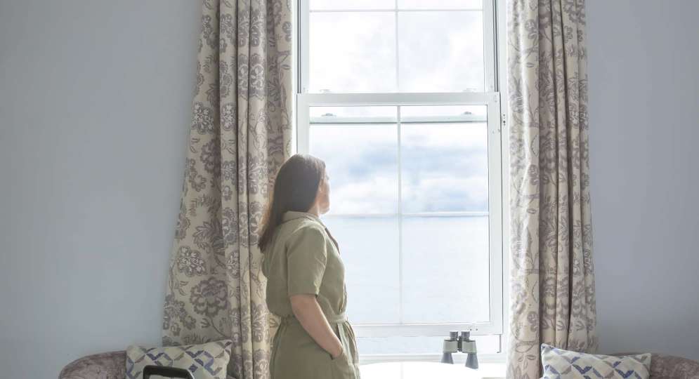 Royal Duchy Hotel Guest Arriving in Her Room and Taking In the Sea View from the Window
