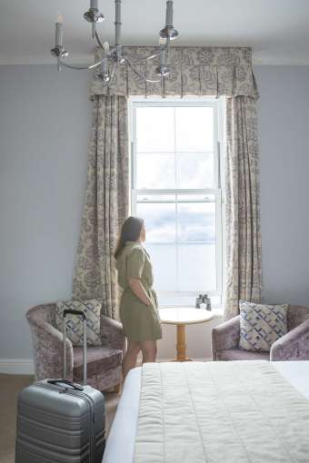 Royal Duchy Hotel Guest Arriving in Her Room and Taking In the Sea View from the Window
