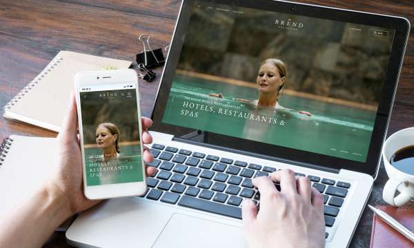 The new Brend Collection website home page displayed on a mobile and a laptop display