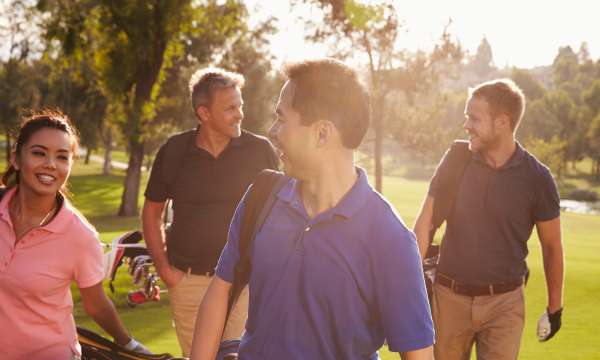 Group of golfers walking toward tee