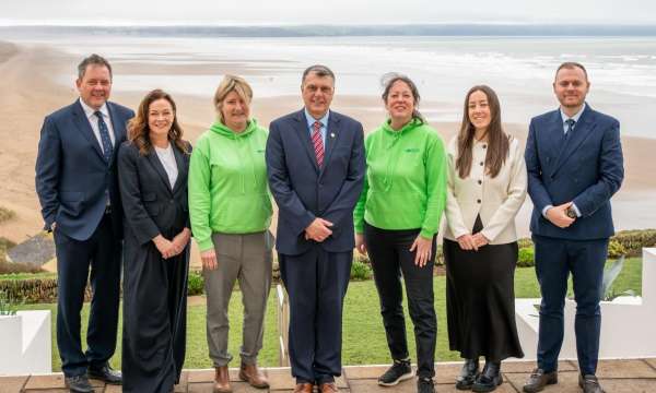 directors or Brend Collection and Children's Hospice Southwest standing in front of the beach at Saunton Sands Hotel