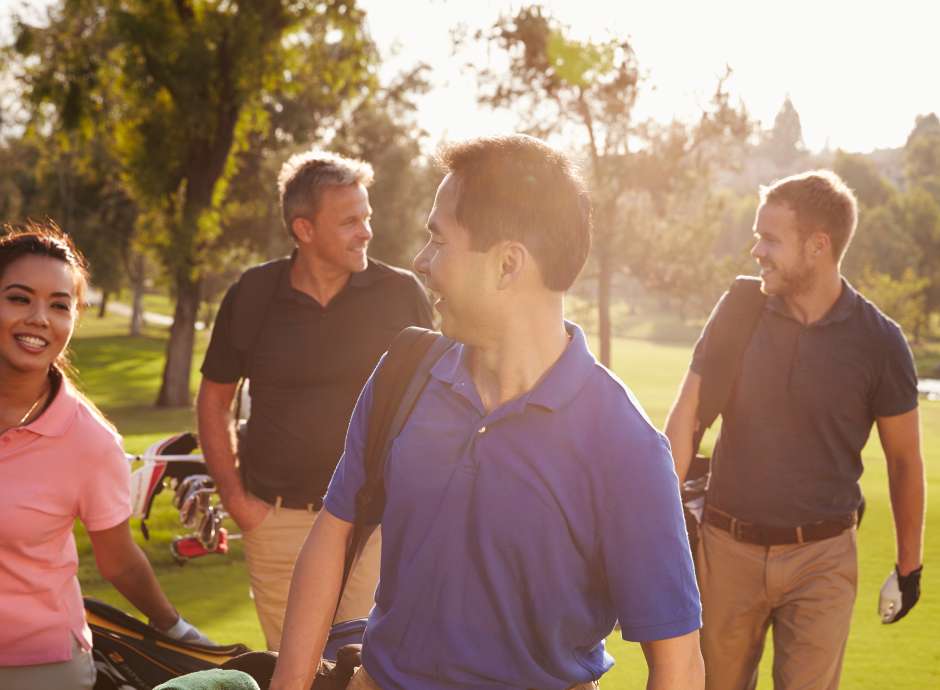 Group of golfers walking toward tee